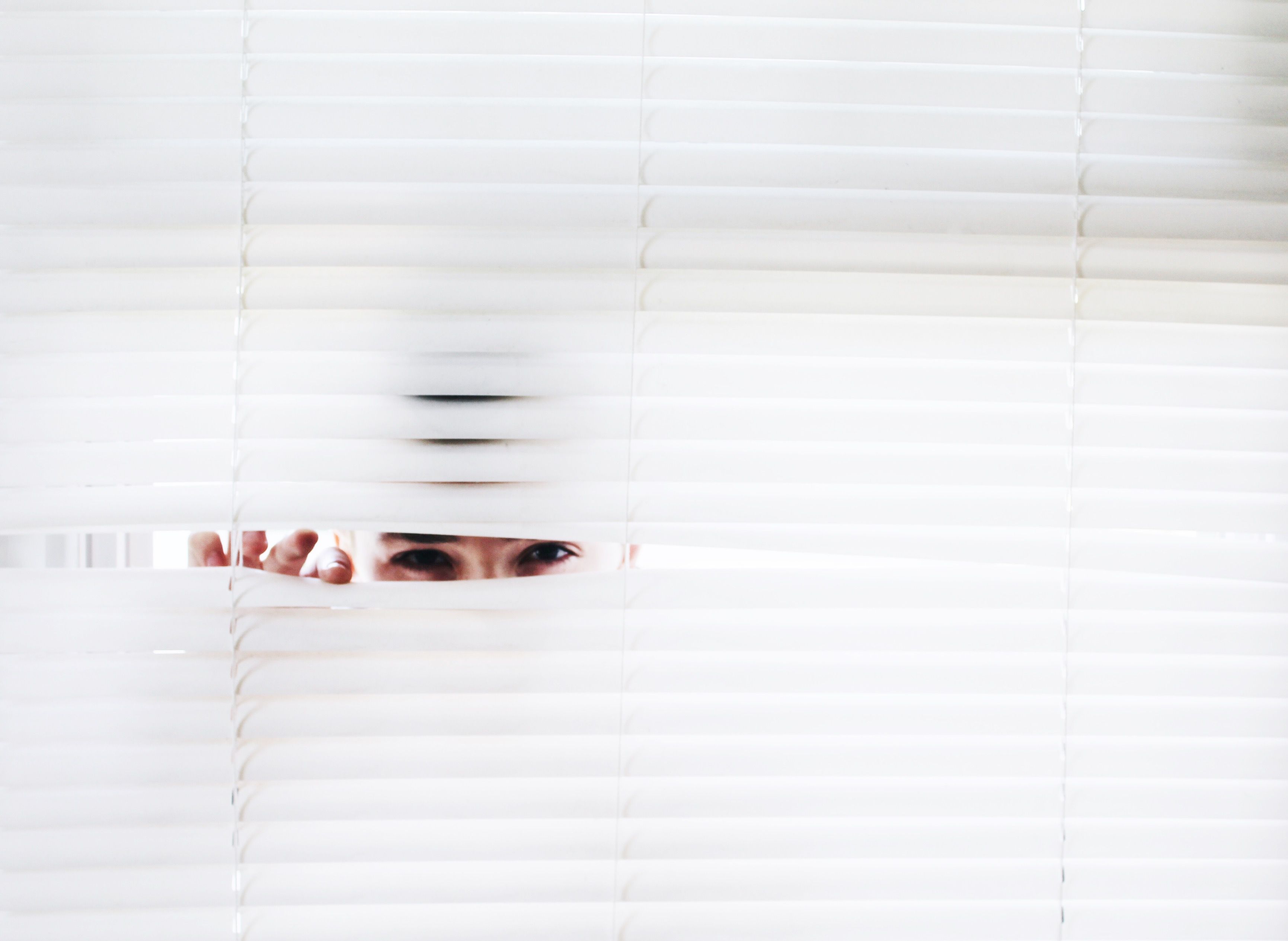 woman looking through blinds, https://www.pexels.com/photo/photography-of-person-peeking-906018/
