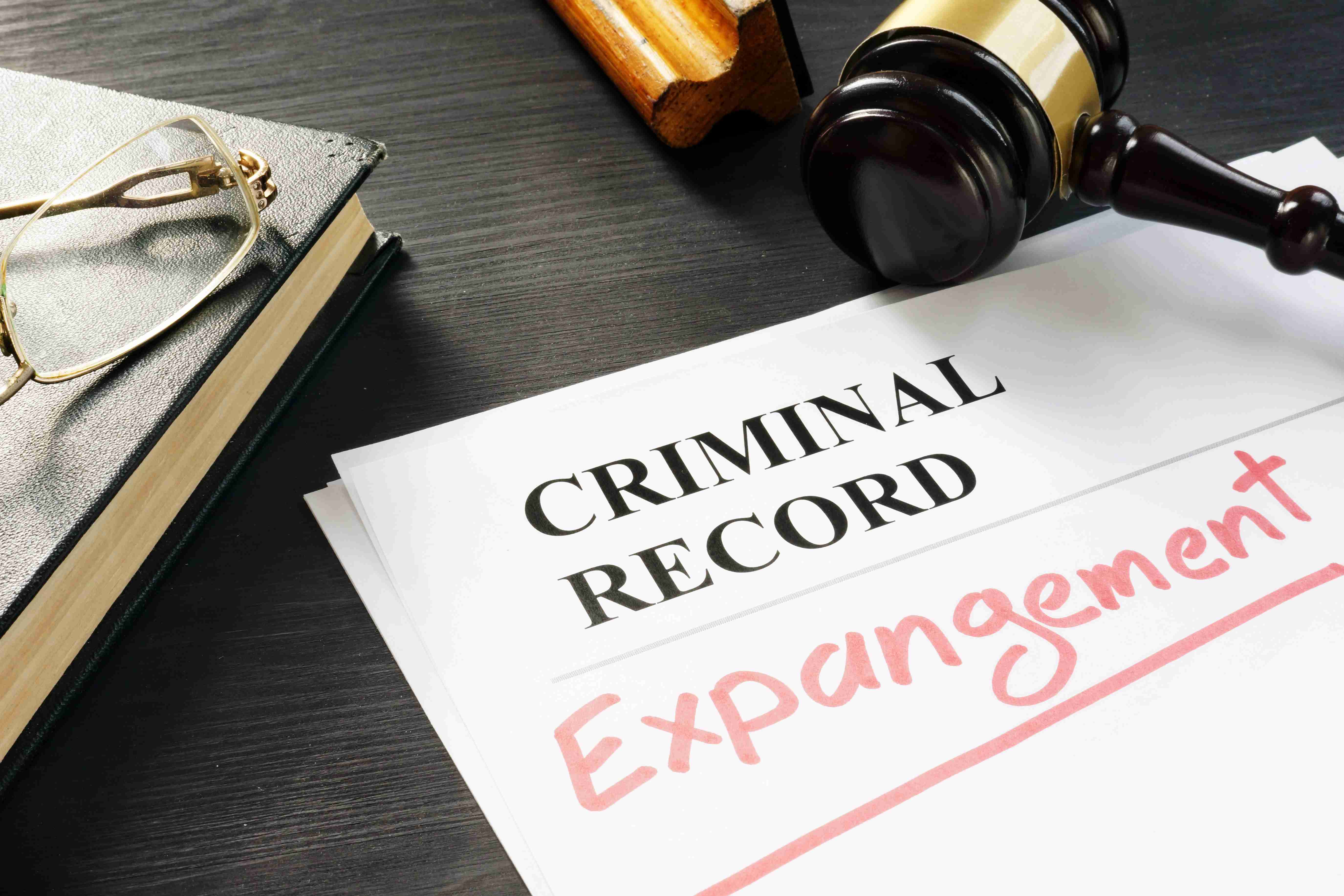 Criminal Record Expungement document with a judge's gavel on a wooden desk.