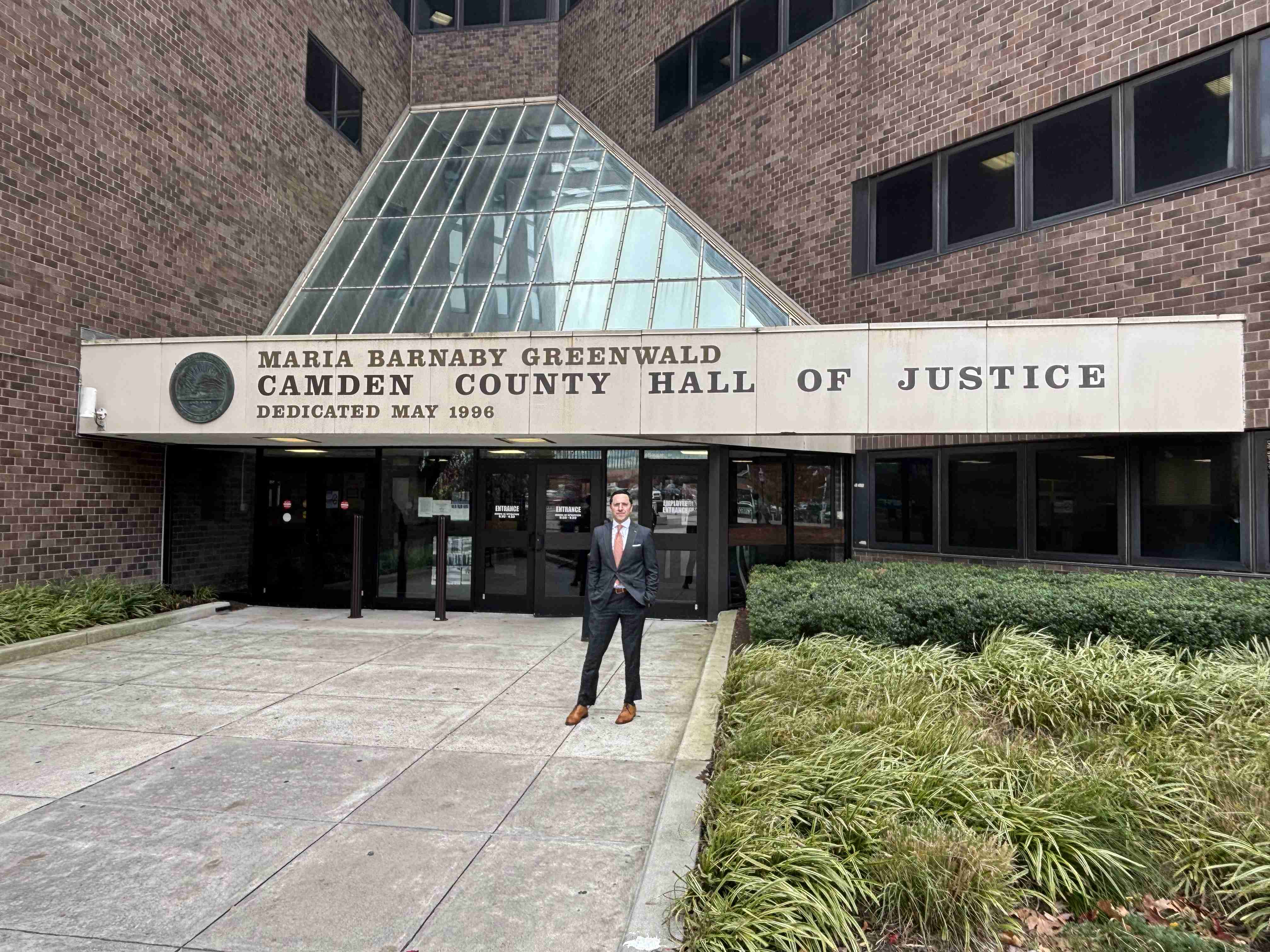 Daniel M. Rosenberg standing in front of the Maria Barnaby Greenwald Camden County Hall of Justice