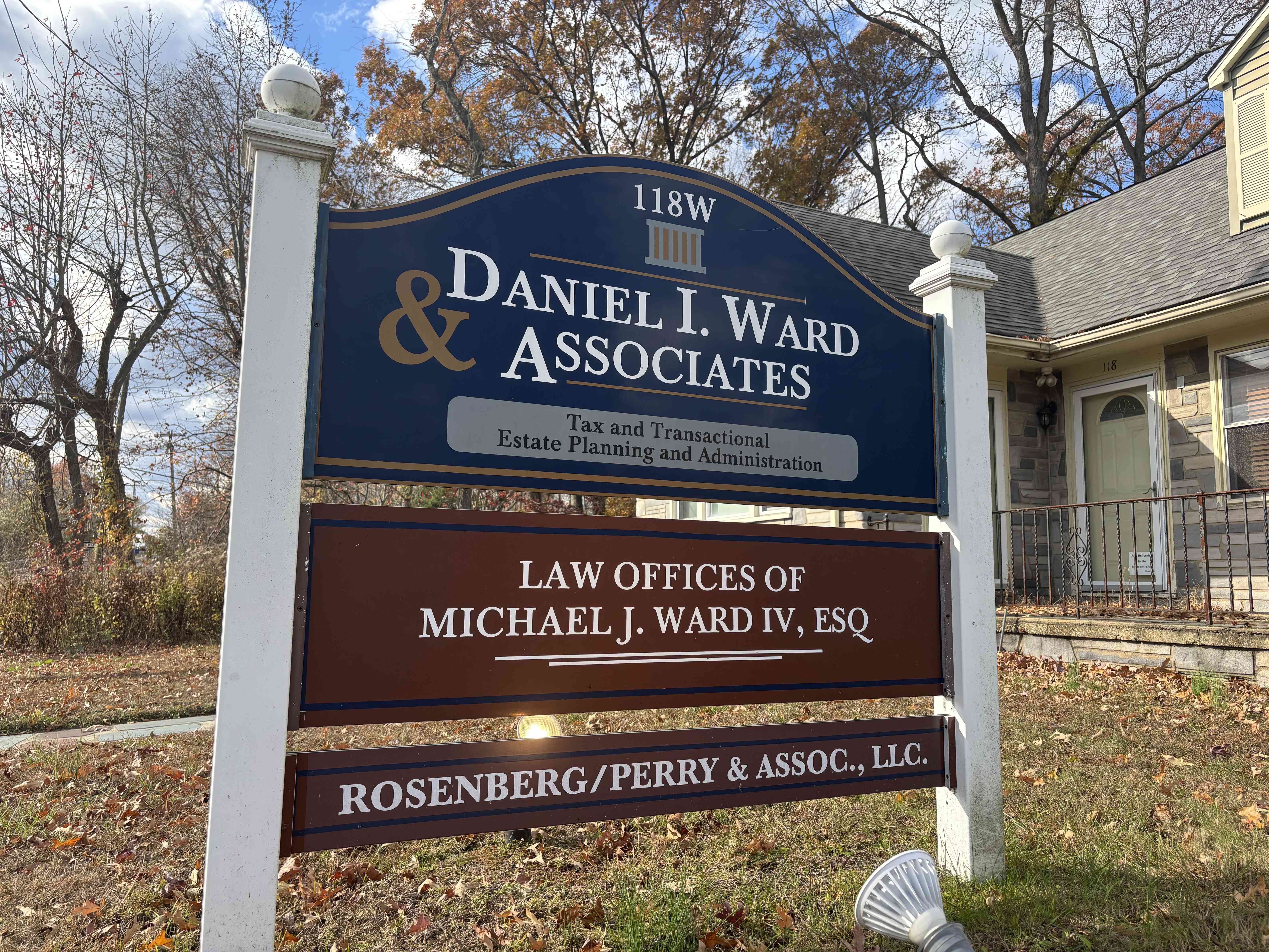 Law firm sign for Daniel I. Ward & Associates, Law Offices of Michael J. Ward IV, and Rosenberg/Perry & Assoc., LLC.